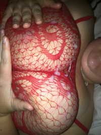 Cumshot over breasts through red lace