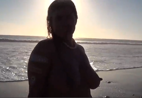 Silhouette of her erect nipple on beach