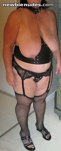 Slut with garter belt, stockings, open bra leather corset, collar, and butt...